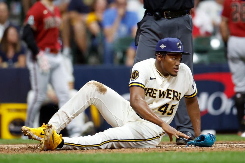 Oct 4, 2023; Milwaukee, Wisconsin, USA;  Milwaukee Brewers relief pitcher Abner Uribe (45) reacts after Arizona Diamondbacks left fielder Tommy Pham (not pictured) scores on a wild pitch in the sixth inning during game two of the Wildcard series for the 2023 MLB playoffs at American Family Field. Mandatory Credit: Kamil Krzaczynski-USA TODAY Sports