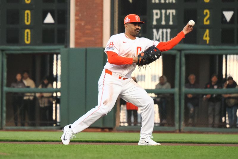 May 14, 2024; San Francisco, California, USA; San Francisco Giants first baseman LaMonte Wade Jr. (31) throws the ball to first base against the Los Angeles Dodgers during the second inning at Oracle Park. Mandatory Credit: Kelley L Cox-USA TODAY Sports