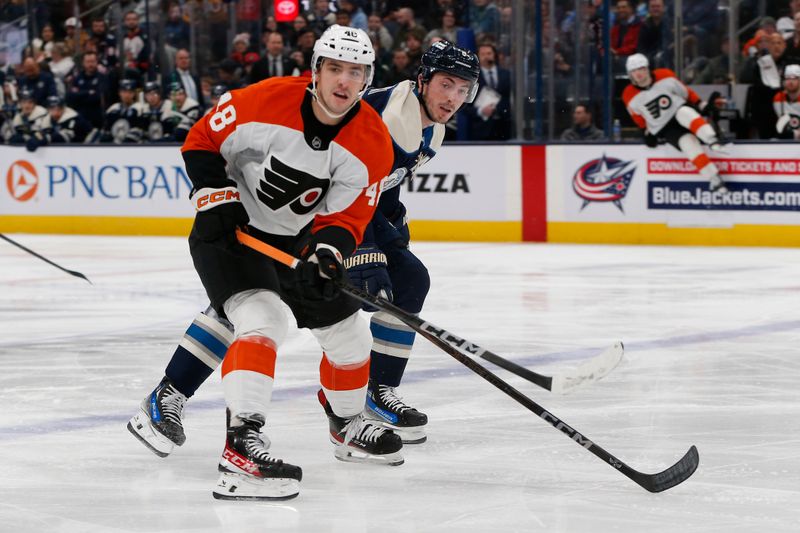 Jan 14, 2025; Columbus, Ohio, USA; Philadelphia Flyers center Morgan Frost (48) looks for a pass as Columbus Blue Jackets defenseman Zach Werenski (8) defends during the second period at Nationwide Arena. Mandatory Credit: Russell LaBounty-Imagn Images