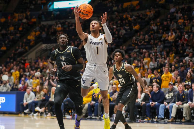 Feb 20, 2024; Morgantown, West Virginia, USA; West Virginia Mountaineers guard Noah Farrakhan (1) shoots in the lane during the second half against the UCF Knights at WVU Coliseum. Mandatory Credit: Ben Queen-USA TODAY Sports