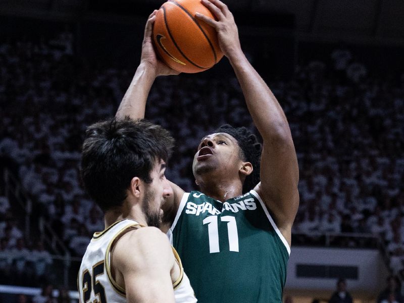 Jan 29, 2023; West Lafayette, Indiana, USA; Michigan State Spartans guard A.J. Hoggard (11) shoots the ball while Purdue Boilermakers guard Ethan Morton (25) defends in the first half at Mackey Arena. Mandatory Credit: Trevor Ruszkowski-USA TODAY Sports