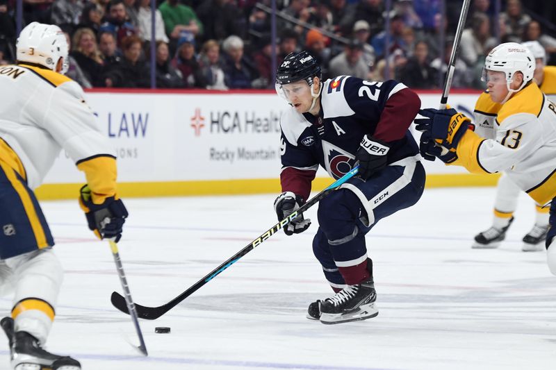 Nov 11, 2024; Denver, Colorado, USA; Colorado Avalanche center Nathan MacKinnon (29) skates the puck into the offensive zone during the second period against the Nashville Predators at Ball Arena. Mandatory Credit: Christopher Hanewinckel-Imagn Images