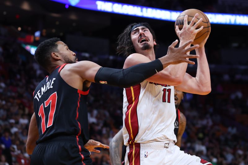 MIAMI, FLORIDA - APRIL 14: Jaime Jaquez Jr. #11 of the Miami Heat drives against Garrett Temple #17 of the Toronto Raptors during the first quarter of the game at Kaseya Center on April 14, 2024 in Miami, Florida. NOTE TO USER: User expressly acknowledges and agrees that, by downloading and or using this photograph, User is consenting to the terms and conditions of the Getty Images License Agreement. (Photo by Megan Briggs/Getty Images)