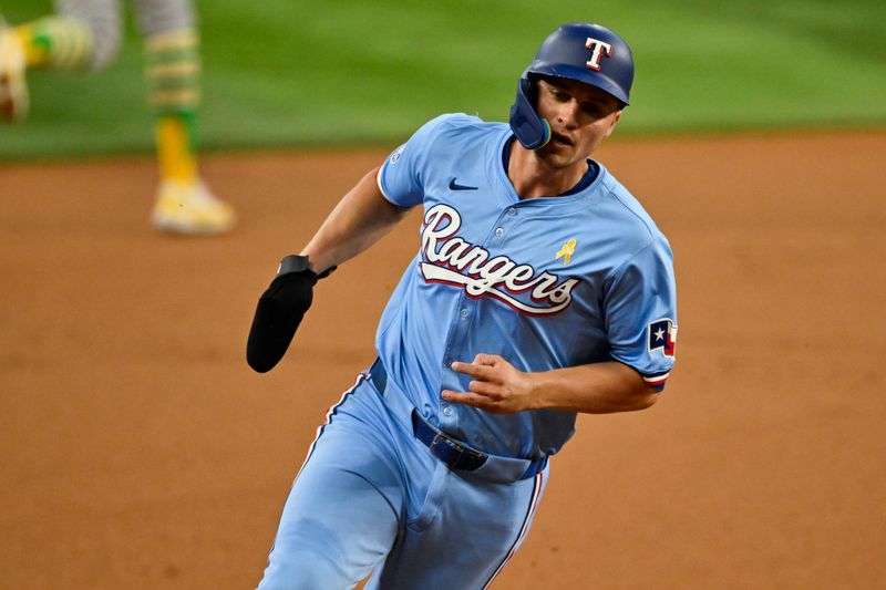 Sep 1, 2024; Arlington, Texas, USA; Texas Rangers shortstop Corey Seager (5) scores from second base on a double hit by right fielder Adolis Garcia (not pictured) during the first inning at Globe Life Field. Mandatory Credit: Jerome Miron-USA TODAY Sports