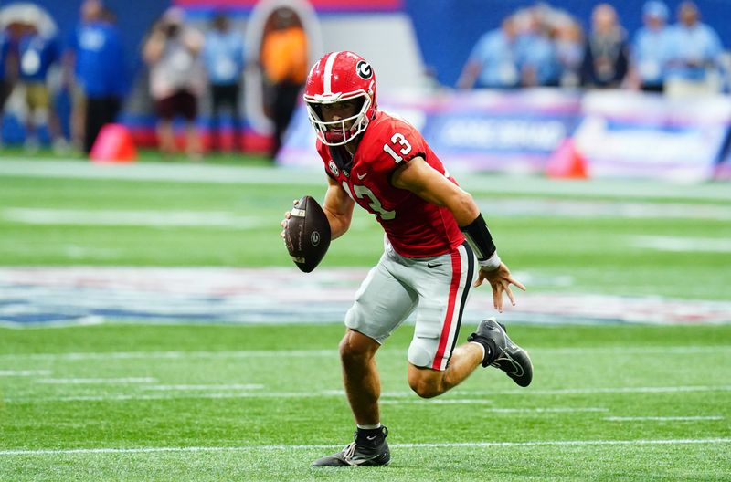 Sep 3, 2022; Atlanta, Georgia, USA; Georgia Bulldogs quarterback Stetson Bennett (13) scrambles out under the Oregon Ducks defense during the first quarter of the Chick-fil-A kickoff game at Mercedes-Benz Stadium. Mandatory Credit: John David Mercer-USA TODAY Sports