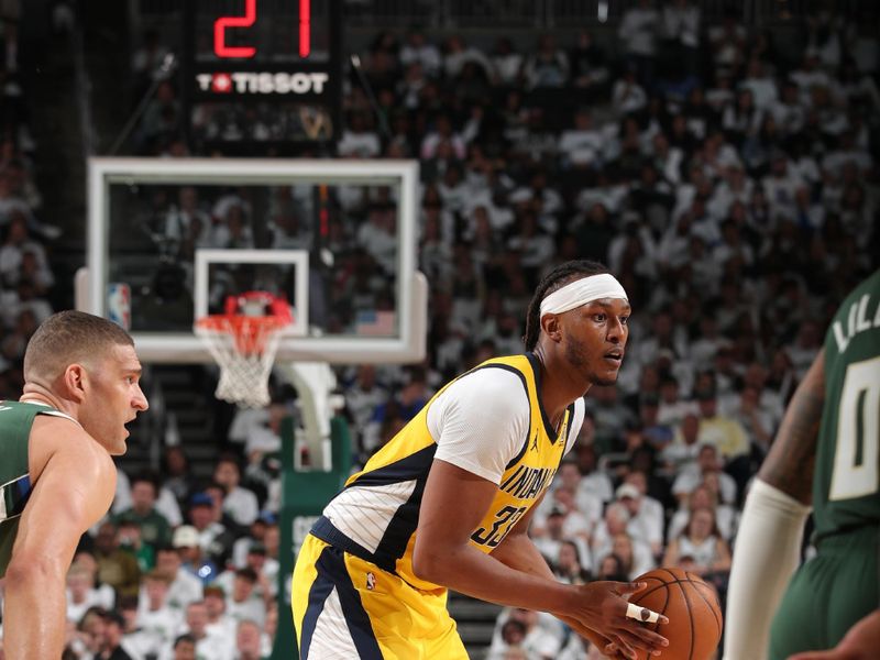 MILWAUKEE, WI - APRIL 23: Myles Turner #33 of the Indiana Pacers handles the ball during the game against the Milwaukee Bucks during Round One Game Two of the 2024 NBA Playoffs on April 23, 2024 at the Fiserv Forum Center in Milwaukee, Wisconsin. NOTE TO USER: User expressly acknowledges and agrees that, by downloading and or using this Photograph, user is consenting to the terms and conditions of the Getty Images License Agreement. Mandatory Copyright Notice: Copyright 2024 NBAE (Photo by Gary Dineen/NBAE via Getty Images).