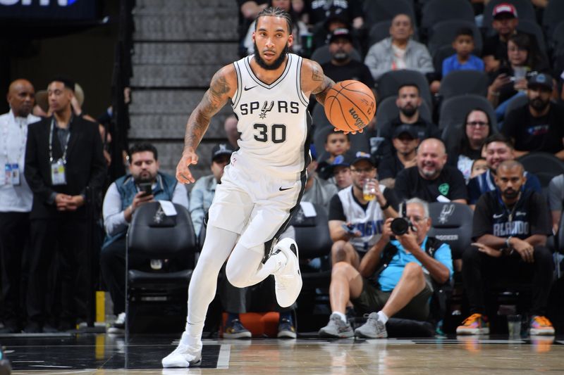 SAN ANTONIO, TX - OCTOBER 9: Julian Champagnie #30 of the San Antonio Spurs dribbles the ball during the game against the Orlando Magic during a NBA preseason game on October 9, 2024 at the Frost Bank Center in San Antonio, Texas. NOTE TO USER: User expressly acknowledges and agrees that, by downloading and or using this photograph, user is consenting to the terms and conditions of the Getty Images License Agreement. Mandatory Copyright Notice: Copyright 2024 NBAE (Photos by Michael Gonzales/NBAE via Getty Images)