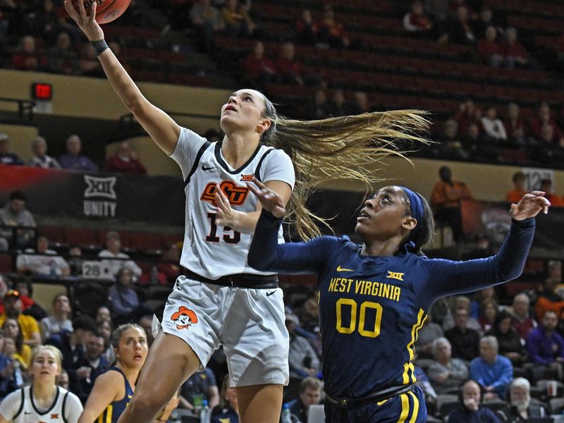 Mar 10, 2023; Kansas City, MO, USA;  Oklahoma State Cowgirls guard Lexy Keys (15) drives to the basket against West Virginia Mountaineers guard Jayla Hemingway (00)during the first half at Municipal Auditorium. Mandatory Credit: Peter Aiken-USA TODAY Sports