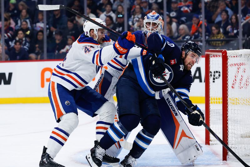 Sep 23, 2025; Winnipeg, Manitoba, CAN;  Edmonton Oilers defenseman Joshua Brown (44) checks Winnipeg Jets forward Tanner Pearson (70) during the second period at Canada Life Centre. Mandatory Credit: Terrence Lee-Imagn Images