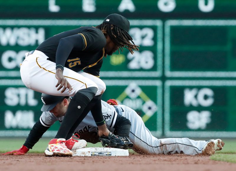 Apr 8, 2023; Pittsburgh, Pennsylvania, USA;  Chicago White Sox left fielder Andrew Benintendi (23) steals second base ahead of a late tag by Pittsburgh Pirates shortstop Oneil Cruz (15) during the third inning at PNC Park. Mandatory Credit: Charles LeClaire-USA TODAY Sports