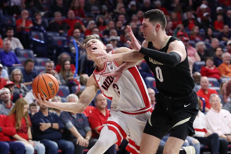 Feb 18, 2023; Tucson, Arizona, USA; Arizona Wildcats guard Pelle Larsson (3) drives to the net against Colorado Buffaloes guard Luke O'Brien (0) during the second half at McKale Center. Mandatory Credit: Zachary BonDurant-USA TODAY Sports