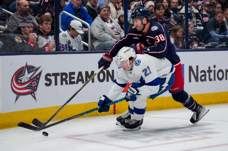 Nov 2, 2023; Columbus, Ohio, USA;  Tampa Bay Lightning center Brayden Point (21) skates with the puck against Columbus Blue Jackets center Boone Jenner (38) in the second period at Nationwide Arena. Mandatory Credit: Aaron Doster-USA TODAY Sports