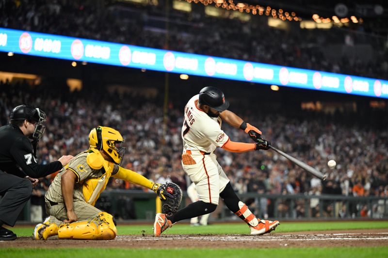 Jun 4, 2025; San Francisco, California, USA; San Francisco Giants left fielder Heliot Ramos (17) hits an RBI double against the San Diego Padres in the seventh inning at Oracle Park. Mandatory Credit: Eakin Howard-Imagn Images