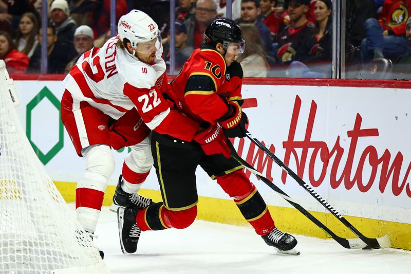 Feb 26, 2026; Ottawa, Ontario, CAN; Detroit Red Wings center Mason Appleton (22) and Ottawa Senators defenseman Jordan Spence (10) vie for the puck during the second period at Canadian Tire Centre. Mandatory Credit: Keito Newman-Imagn Images