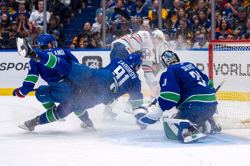 May 20, 2024; Vancouver, British Columbia, CAN; Vancouver Canucks goalie Arturs Silvos (31) makes a save on Edmonton Oilers forward Evander Kane (91) as forward Conor Garland (8) and defenseman Nikita Zadorov (91) collide during the second period in game seven of the second round of the 2024 Stanley Cup Playoffs at Rogers Arena. Mandatory Credit: Bob Frid-USA TODAY Sports