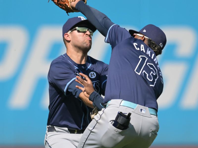 Sep 15, 2024; Cleveland, Ohio, USA; Tampa Bay Rays third baseman Junior Caminero (13) catches a pop up in front of left fielder Dylan Carlson (10) hit by Cleveland Guardians left fielder Angel Martinez (not pictured) during the second inning at Progressive Field. Mandatory Credit: Ken Blaze-Imagn Images