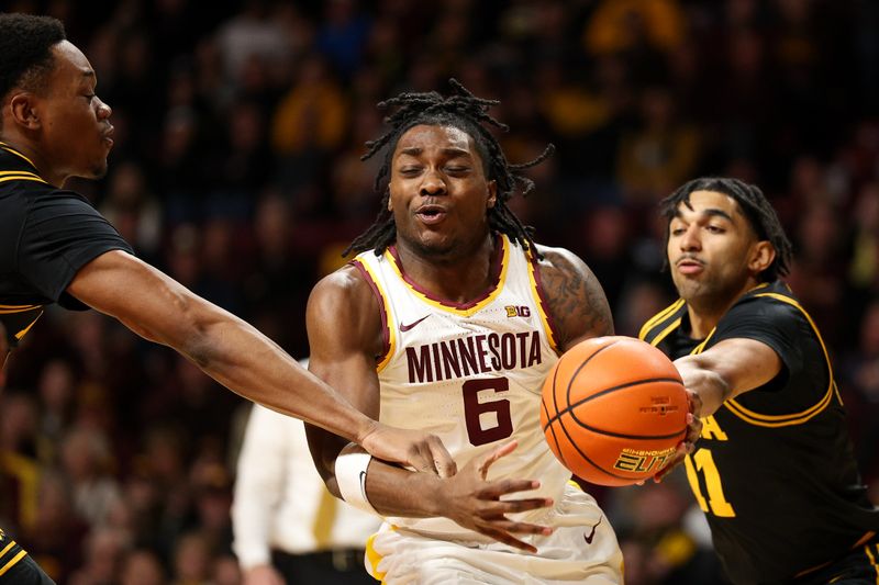 Jan 6, 2026; Minneapolis, Minnesota, USA; Minnesota Golden Gophers guard Langston Reynolds (6) drives towards the basket as Iowa Hawkeyes forward Cam Manyawu (3) and guard Kael Combs (11) defend during the first half at Williams Arena. Mandatory Credit: Matt Krohn-Imagn Images