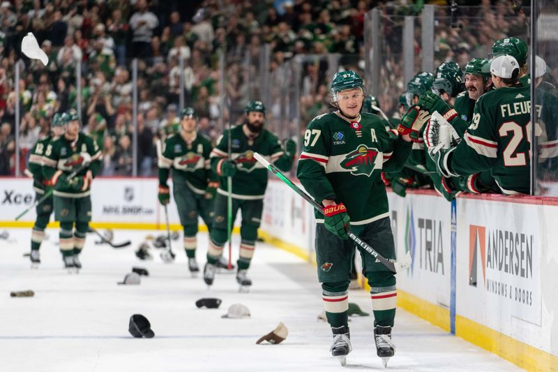 Mar 3, 2024; Saint Paul, Minnesota, USA; Minnesota Wild left wing Kirill Kaprizov (97) celebrates his third goal of the game as hats rain down on the ice in the third period against the San Jose Sharks at Xcel Energy Center. Mandatory Credit: Matt Blewett-USA TODAY Sports