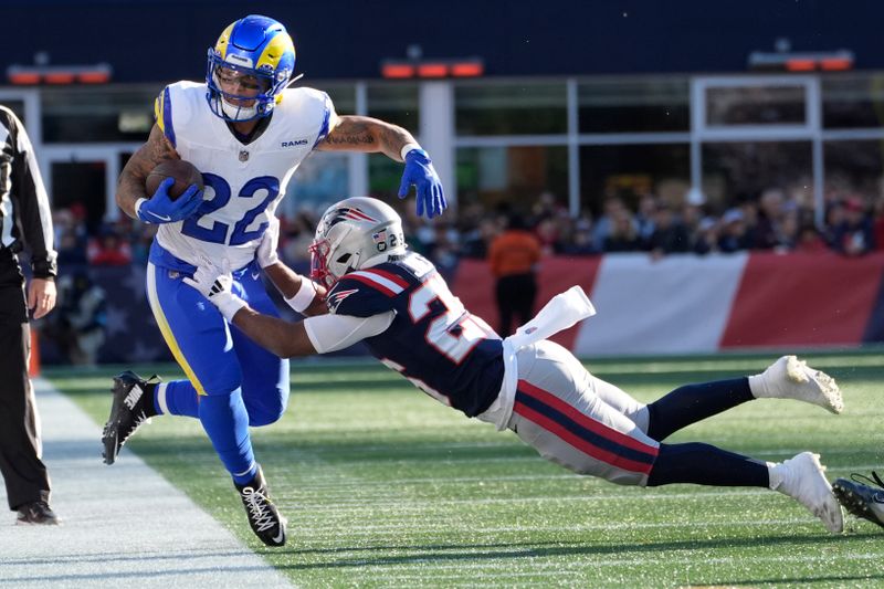 Los Angeles Rams running back Blake Corum (22) is pushed out of bounds by New England Patriots cornerback Marcus Jones during the first half of an NFL football game, Sunday, Nov. 17, 2024, in Foxborough, Mass. (AP Photo/Michael Dwyer)