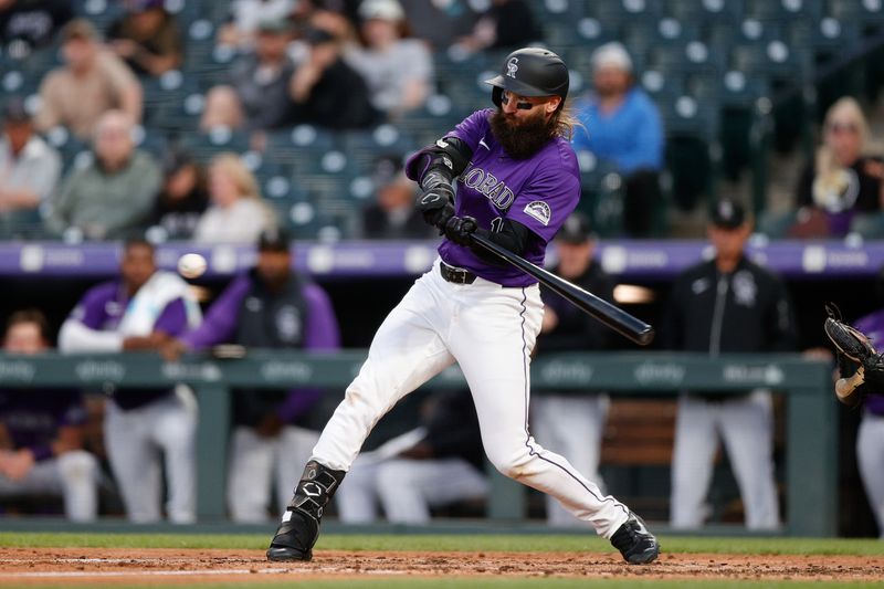Apr 22, 2024; Denver, Colorado, USA; Colorado Rockies designated hitter Charlie Blackmon (19) hits a double in the fourth inning against the San Diego Padres at Coors Field. Mandatory Credit: Isaiah J. Downing-USA TODAY Sports