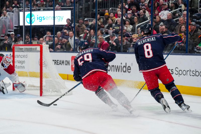 Nov 29, 2023; Columbus, Ohio, USA;  Columbus Blue Jackets right wing Yegor Chinakhov (59) scores a goal as he skates alongside defenseman Zach Werenski (8) in the game against the Montreal Canadiens in the second period at Nationwide Arena. Mandatory Credit: Aaron Doster-USA TODAY Sports