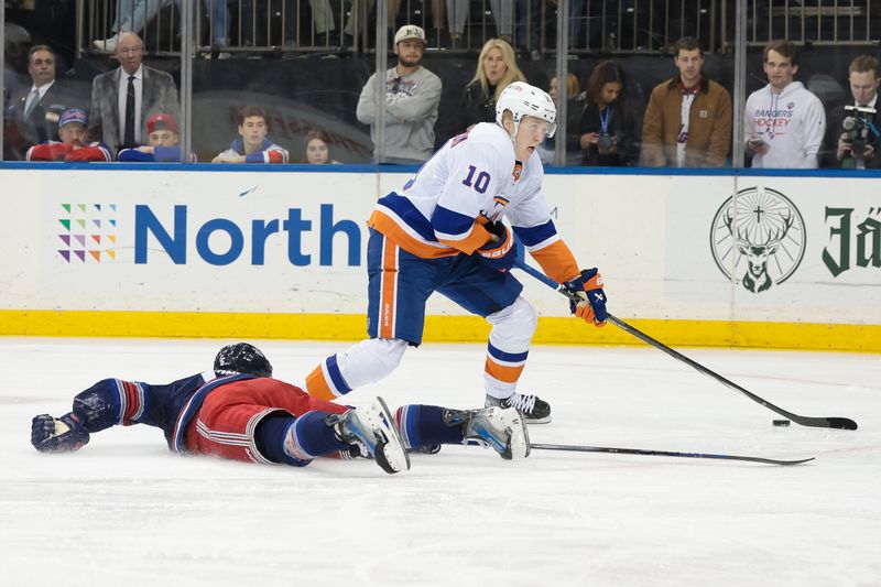 Mar 17, 2024; New York, New York, USA; New York Islanders right wing Simon Holmstrom (10) skates past New York Rangers defenseman Zac Jones (6) during the first period at Madison Square Garden. Mandatory Credit: Vincent Carchietta-USA TODAY Sports