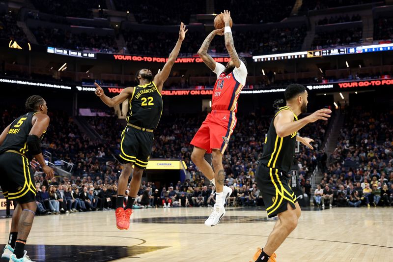 SAN FRANCISCO, CALIFORNIA - JANUARY 10: Brandon Ingram #14 of the New Orleans Pelicans shoots over Andrew Wiggins #22 of the Golden State Warriors in the first half at Chase Center on January 10, 2024 in San Francisco, California. NOTE TO USER: User expressly acknowledges and agrees that, by downloading and or using this photograph, User is consenting to the terms and conditions of the Getty Images License Agreement.  (Photo by Ezra Shaw/Getty Images)