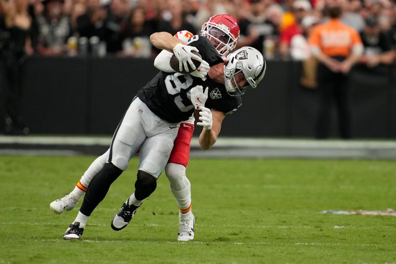 Las Vegas Raiders tight end Brock Bowers, front, catches a pass as Kansas City Chiefs cornerback Trent McDuffie (22) defends during the first half of an NFL football game Sunday, Oct. 27, 2024, in Las Vegas. (AP Photo/John Locher)