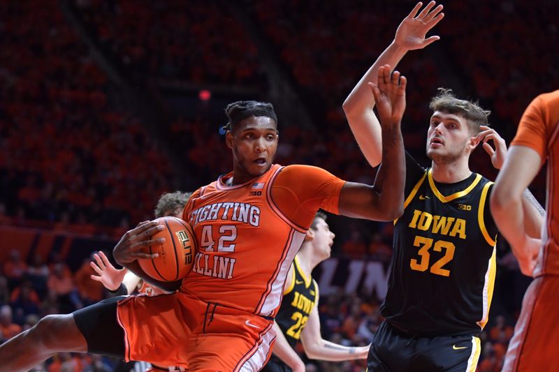 Feb 24, 2024; Champaign, Illinois, USA;  Illinois Fighting Illini forward Dain Dainja (42) pulls away a rebound from Iowa Hawkeyes forward Owen Freeman (32) during the second half at State Farm Center. Mandatory Credit: Ron Johnson-USA TODAY Sports