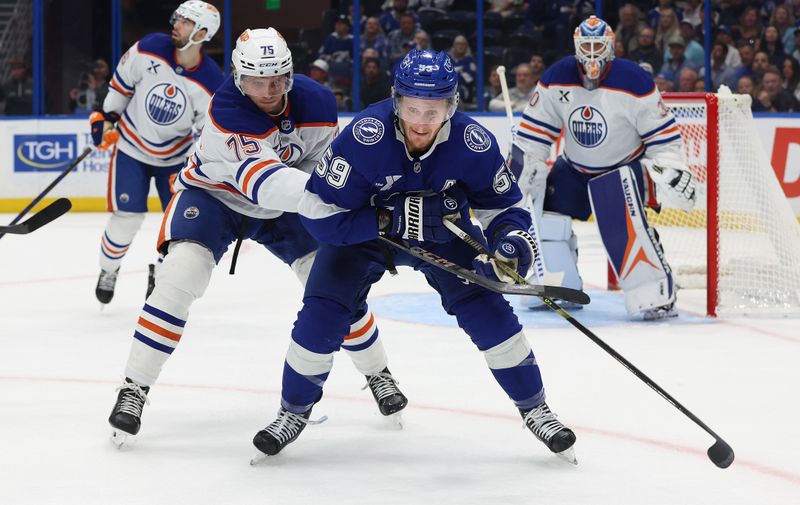 Nov 20, 2025; Tampa, Florida, USA;  Edmonton Oilers defenseman Alec Regula (75) defends against Tampa Bay Lightning center Jake Guentzel (59) during the first period at Benchmark International Arena. Mandatory Credit: Kim Klement Neitzel-Imagn Images