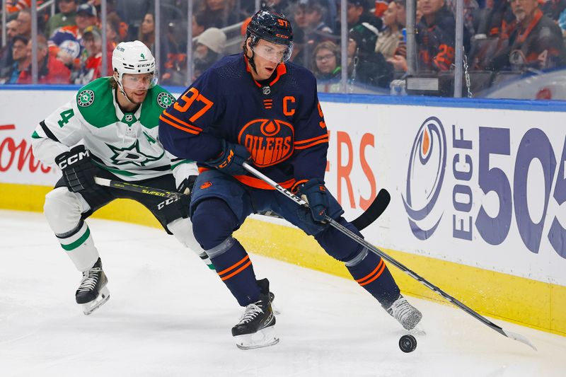 Nov 2, 2023; Edmonton, Alberta, CAN; Edmonton Oilers forward Connor McDavid (97) protects the puck from Dallas Stars defensemen Miro Heiskanen (4) during the first period at Rogers Place. Mandatory Credit: Perry Nelson-USA TODAY Sports