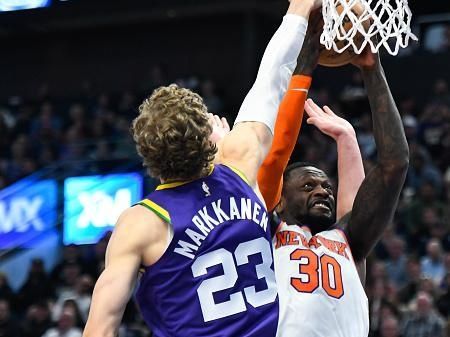 SALT LAKE CITY, UTAH - DECEMBER 13: Lauri Markkanen #23 of the Utah Jazz blocks Julius Randle #30 of the New York Knicks during the first half of a game at Delta Center on December 13, 2023 in Salt Lake City, Utah. NOTE TO USER: User expressly acknowledges and agrees that, by downloading and or using this photograph, User is consenting to the terms and conditions of the Getty Images License Agreement. (Photo by Alex Goodlett/Getty Images)