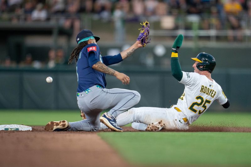 May 6, 2025; West Sacramento, California, USA;   Athletics designated hitter Brent Rooker (25) steals second base against Seattle Mariners second baseman Leo Rivas (76) during the third inning at Sutter Health Park. Mandatory Credit: Neville E. Guard-Imagn Images