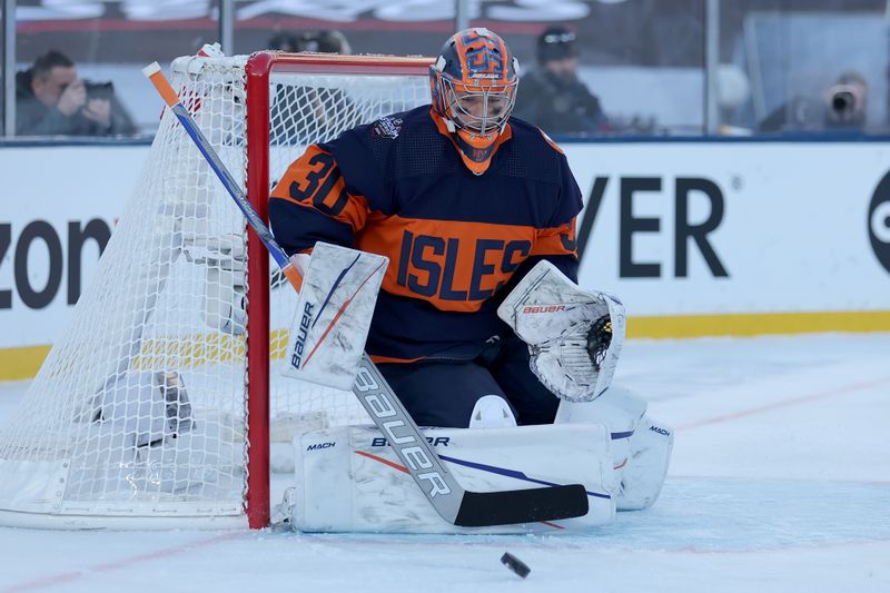 Feb 18, 2024; East Rutherford, New Jersey, USA; New York Islanders goaltender Ilya Sorokin (30) makes a save against the New York Rangers during the first period of a Stadium Series ice hockey game at MetLife Stadium. Mandatory Credit: Brad Penner-USA TODAY Sports