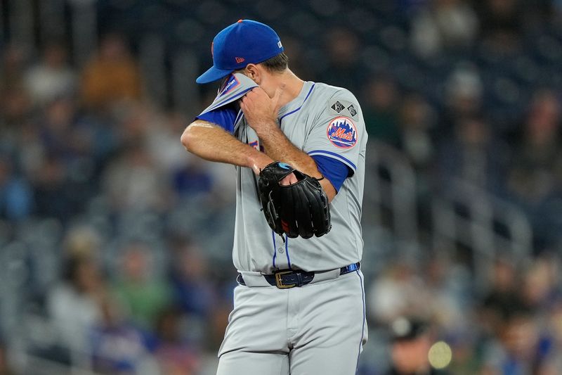 Sep 10, 2024; Toronto, Ontario, CAN;  New York Mets starting pitcher David Peterson (23) wipes his face with his jersey during the third inning against the Toronto Blue Jays at Rogers Centre. Mandatory Credit: John E. Sokolowski-Imagn Images