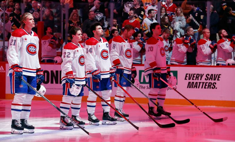 Feb 22, 2024; Pittsburgh, Pennsylvania, USA; Montreal Canadiens starting line up (L to R) defenseman Kaiden Guhle (21) and right wing Cole Caufield (22) and center Nick Suzuki (14) and defenseman Mike Matheson (8) and left wing Juraj Slafkovsky (20) stand for the Canadian National Anthem against the Pittsburgh Penguins at PPG Paints Arena. Mandatory Credit: Charles LeClaire-USA TODAY Sports