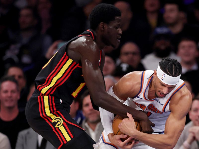 NEW YORK, NEW YORK - FEBRUARY 12:  Mouhamed Gueye #18 of the Atlanta Hawks and Josh Hart #3 of the New York Knicks fight for the ball in the first half at Madison Square Garden on February 12, 2025 in New York City. NOTE TO USER: User expressly acknowledges and agrees that, by downloading and or using this photograph, User is consenting to the terms and conditions of the Getty Images License Agreement. (Photo by Elsa/Getty Images)