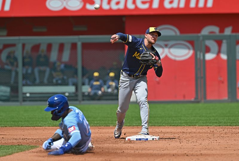 May 8, 2024; Kansas City, Missouri, USA; Milwaukee Brewers second baseman Brice Turang (2) throws the ball to first base over Kansas City Royals Maikel Garcia (11) in the third inning at Kauffman Stadium. Mandatory Credit: Peter Aiken-USA TODAY Sports