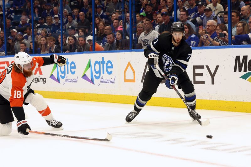 Mar 9, 2024; Tampa, Florida, USA; Tampa Bay Lightning center Anthony Cirelli (71) passes the puck against Philadelphia Flyers defenseman Marc Staal (18) during the first period at Amalie Arena. Mandatory Credit: Kim Klement Neitzel-USA TODAY Sports