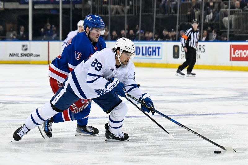 Mar 20, 2025; New York, New York, USA;  New York Rangers defenseman Adam Fox (23) defends against Toronto Maple Leafs left wing Nicholas Robertson (89) during the third period at Madison Square Garden. Mandatory Credit: Dennis Schneidler-Imagn Images