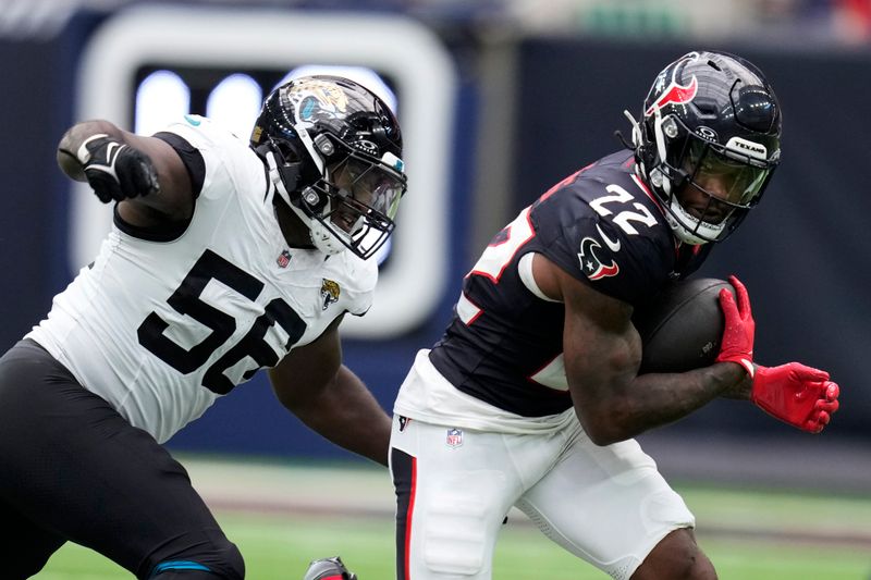 Houston Texans running back Cam Akers (22) runs from Jacksonville Jaguars linebacker Yasir Abdullah (56) during the second half of an NFL football game, Sunday, Sept. 29, 2024, in Houston. (AP Photo/Eric Christian Smith)