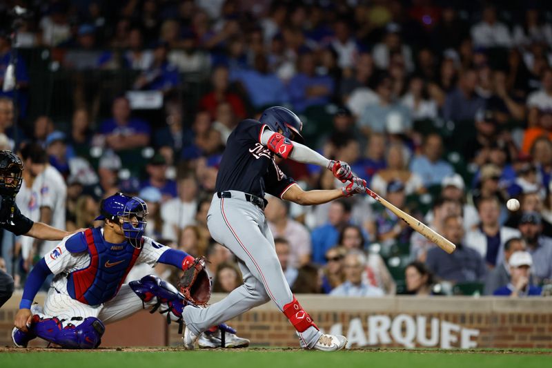 Sep 19, 2024; Chicago, Illinois, USA; Washington Nationals third baseman Jose Tena (8) hits an RBI single against the Chicago Cubs during the third inning at Wrigley Field. Mandatory Credit: Kamil Krzaczynski-Imagn Images