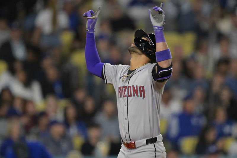 May 20, 2024; Los Angeles, California, USA;  Arizona Diamondbacks left fielder Lourdes Gurriel Jr. (12) crosses the plate after hitting a solo home run in the eighth inning against the Los Angeles Dodgers at Dodger Stadium. Mandatory Credit: Jayne Kamin-Oncea-USA TODAY Sports