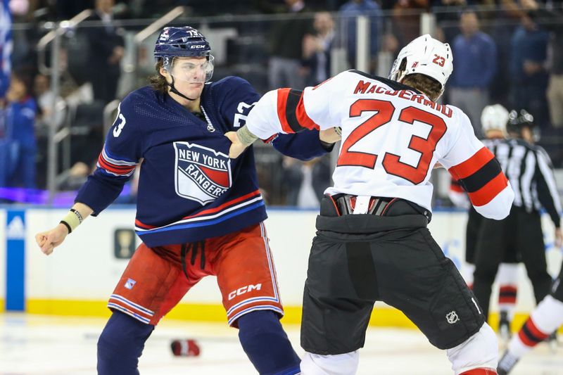 Apr 3, 2024; New York, New York, USA; New York Rangers center Matt Rempe (73) and New Jersey Devils defenseman Kurtis MacDermid (23) fight at start of the 1st period at Madison Square Garden. Mandatory Credit: Wendell Cruz-USA TODAY Sports