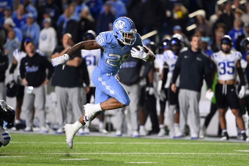 Nov 11, 2023; Chapel Hill, North Carolina, USA; North Carolina Tar Heels running back Omarion Hampton (28) runs in the second quarter at Kenan Memorial Stadium. Mandatory Credit: Bob Donnan-USA TODAY Sports