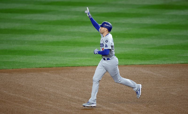 Oct 28, 2024; New York, New York, USA; Los Angeles Dodgers first baseman Freddie Freeman (5) celebrates after hitting a two-run home run during the first inning in game three of the 2024 MLB World Series against the New York Yankees at Yankee Stadium. Mandatory Credit: Vincent Carchietta-Imagn Images