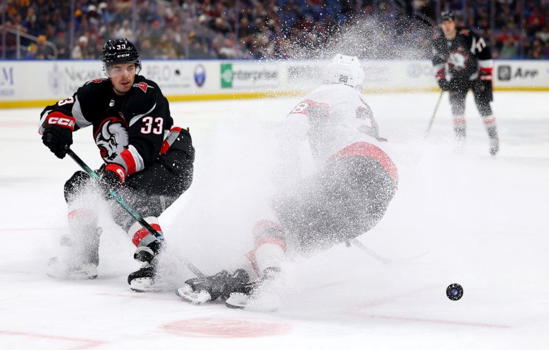 Jan 11, 2024; Buffalo, New York, USA;  Buffalo Sabres defenseman Ryan Johnson (33) knocks the puck off the stick of Ottawa Senators right wing Claude Giroux (28) during the second period at KeyBank Center. Mandatory Credit: Timothy T. Ludwig-USA TODAY Sports