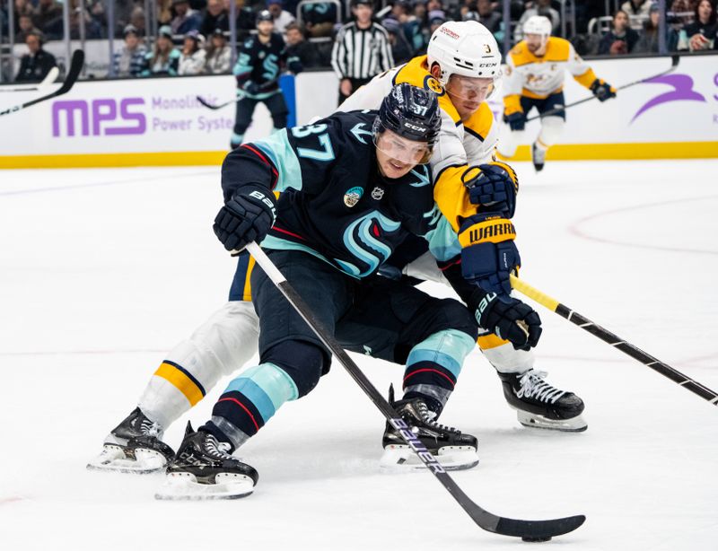 Nov 20, 2024; Seattle, Washington, USA;  Seattle Kraken forward Yanni Gourde (37) skates against Nashville Predators defenseman Jeremy Lauzon (3) during the second period at Climate Pledge Arena. Mandatory Credit: Stephen Brashear-Imagn Images