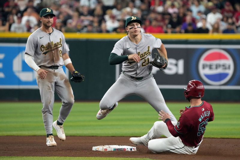 Jun 29, 2024; Phoenix, Arizona, USA; Oakland Athletics second base Zack Gelof (20) turns the double play while avoiding Arizona Diamondbacks first base Christian Walker (53) in the fourth inning at Chase Field. Mandatory Credit: Rick Scuteri-USA TODAY Sports