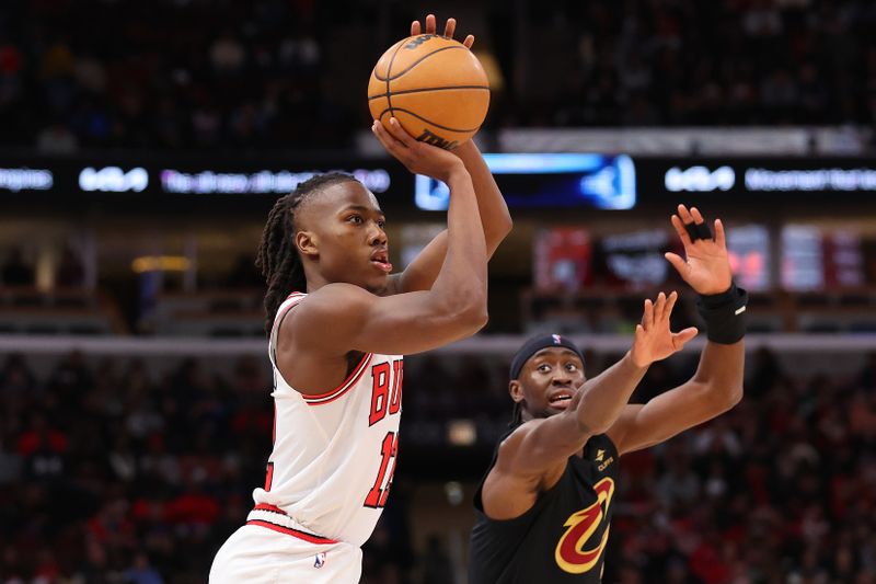 CHICAGO, ILLINOIS - FEBRUARY 28: Ayo Dosunmu #12 of the Chicago Bulls shoots a three pointer against the Cleveland Cavaliers during the second half at the United Center on February 28, 2024 in Chicago, Illinois. NOTE TO USER: User expressly acknowledges and agrees that, by downloading and or using this photograph, User is consenting to the terms and conditions of the Getty Images License Agreement. (Photo by Michael Reaves/Getty Images)